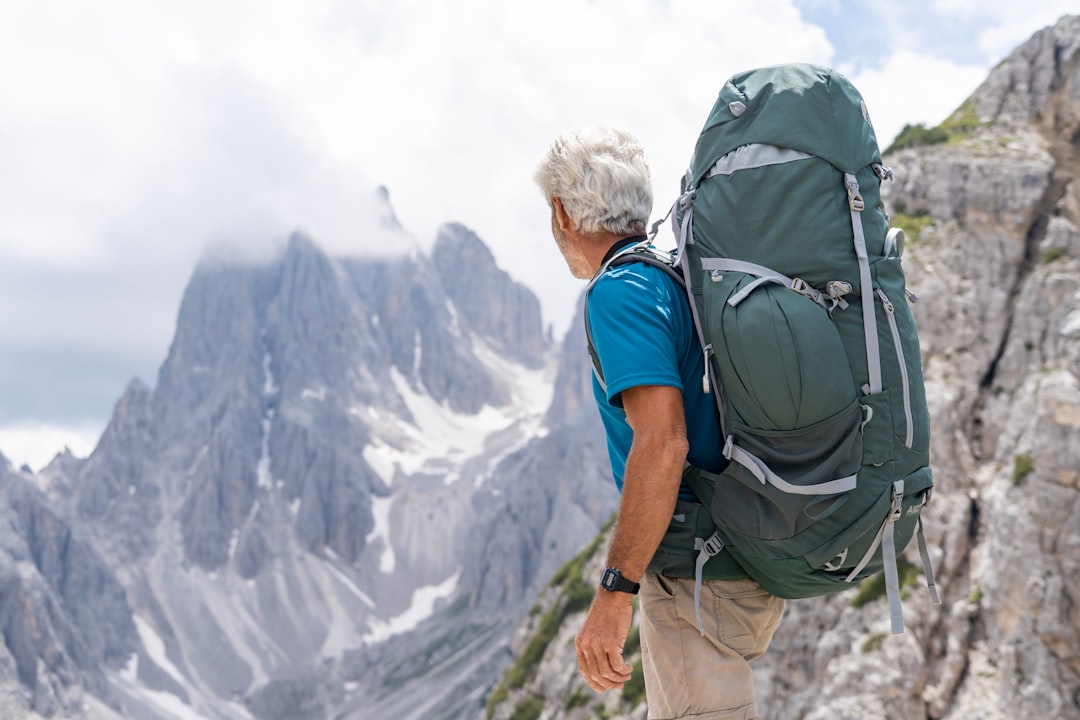 a man with a backpack on top of a mountain