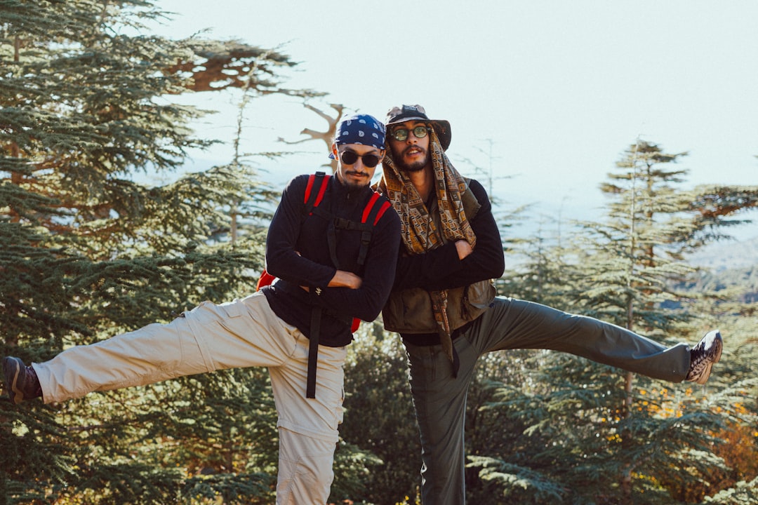 Two friends posing playfully on a scenic mountain overlook